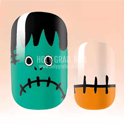 Close-up Halloween nail art wraps featuring cute Frankenstein monster face with stitched mouth design