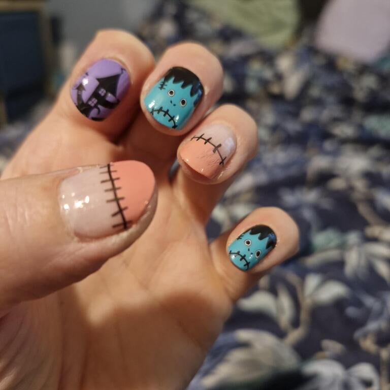 Halloween nail wraps: teal Frankenstein faces, purple haunted house, peach stitched design