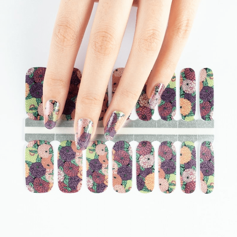 Floral geranium nail wraps on hand with botanical multicoloured vintage pattern design