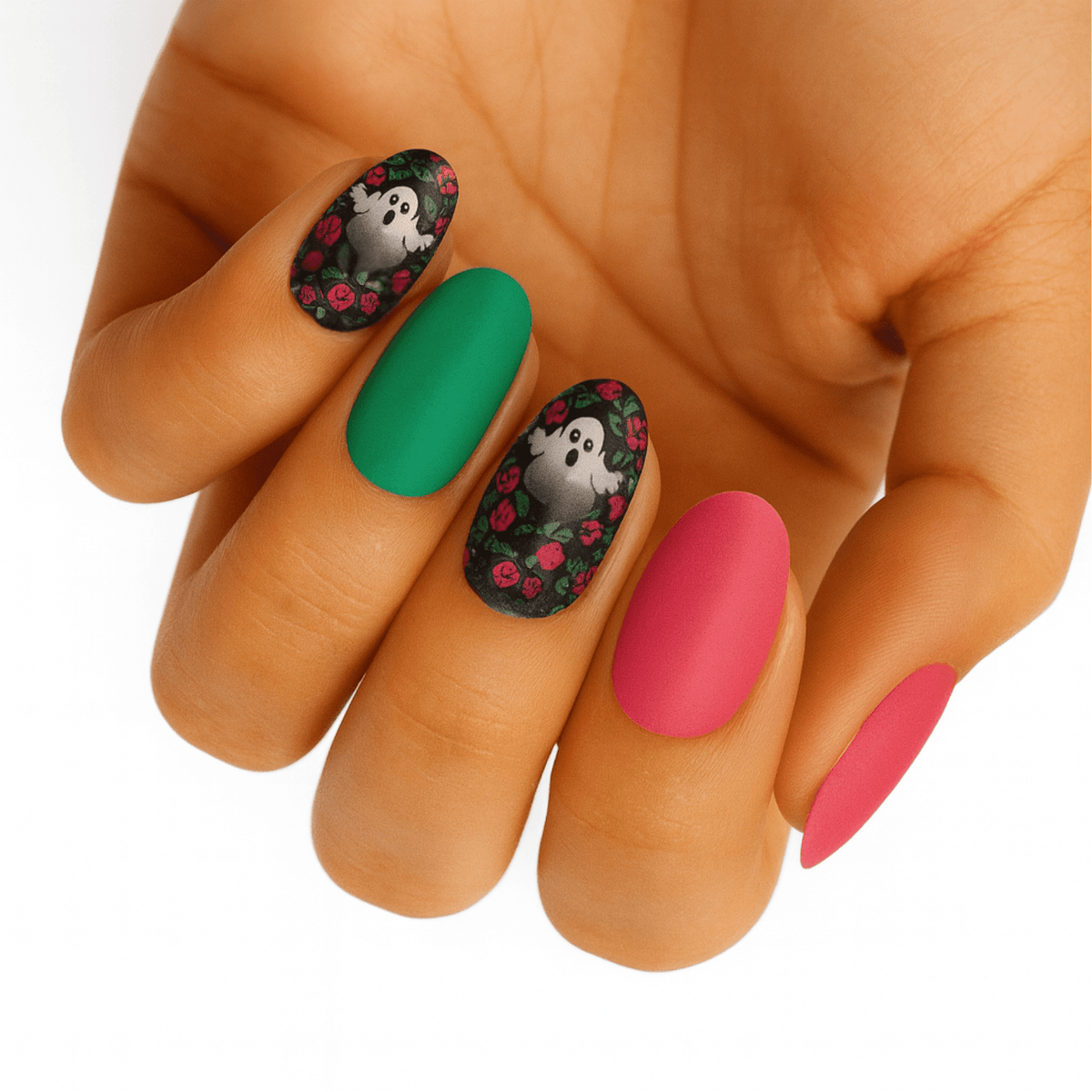 Matte nail wraps mixing emerald and pink shades with black rose-and-ghost Halloween accent nails.