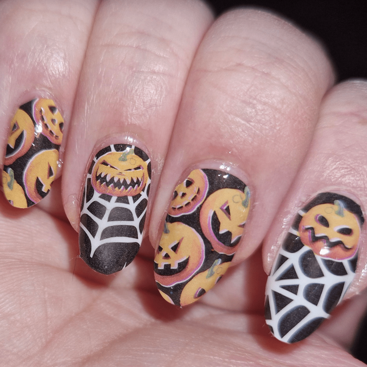 Holy Classics nail wraps, black with orange jack-o'-lantern faces and spiderweb design