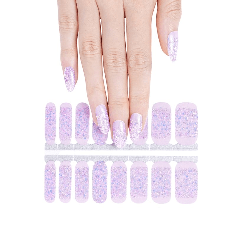 Hand displaying purple glitter nail wraps with sparkly gradient finish for at-home manicure