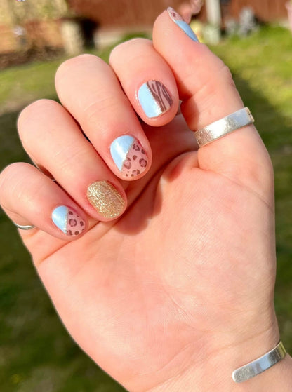 Mixed pattern nail art featuring blue leopard print and gold glitter nail wraps
