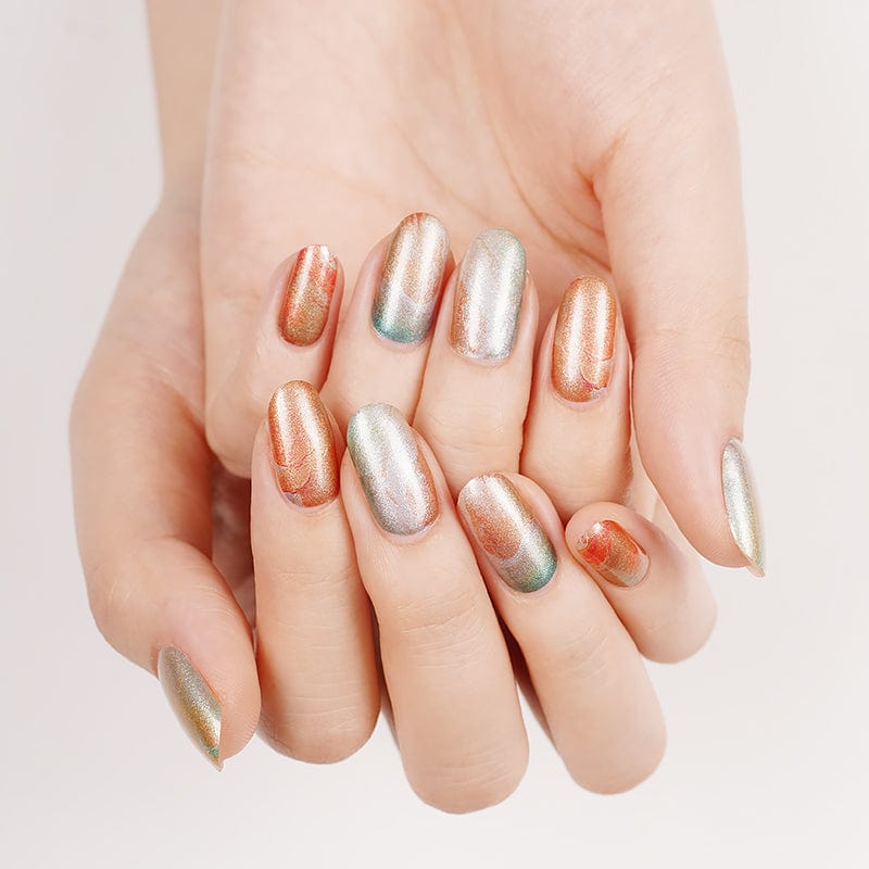 Mixed metallic nail wraps in gold silver and copper tones on hands
