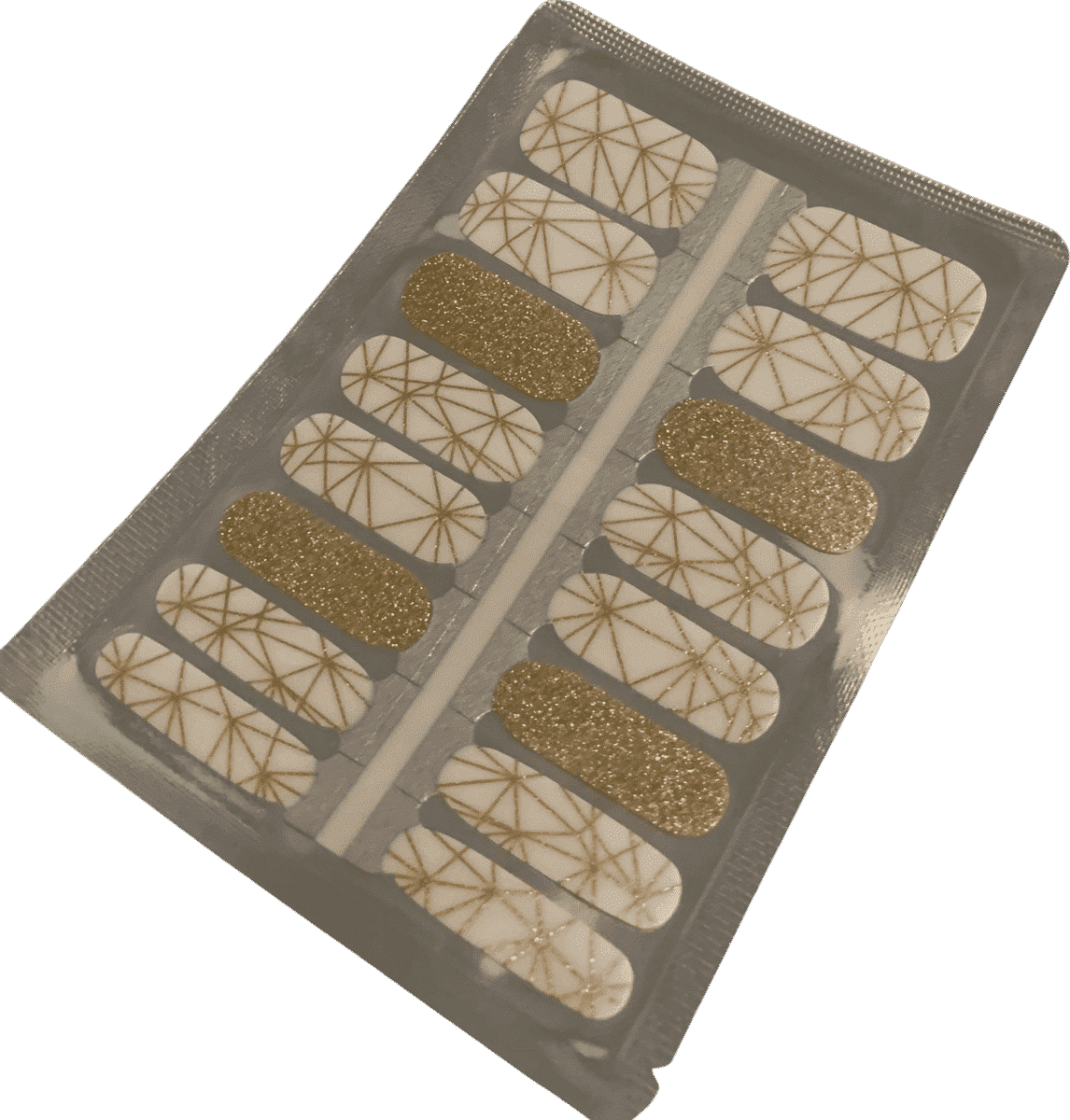 Gold geometric non-UV nail wraps with metallic glitter and white patterns on sheet