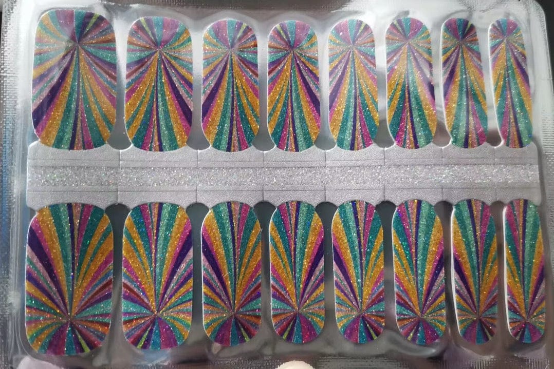 Holy Classics nail wraps with glittery kaleidoscope rays in teal, gold, pink and purple
