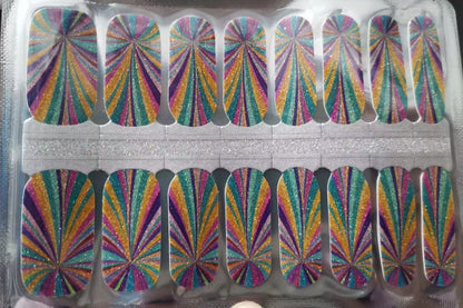 Holy Classics nail wraps with glittery kaleidoscope rays in teal, gold, pink and purple
