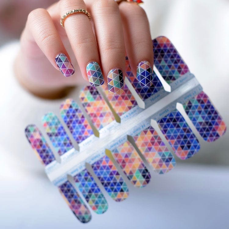 Geometric triangle mosaic nail wraps on hand showing multicoloured gradient pattern