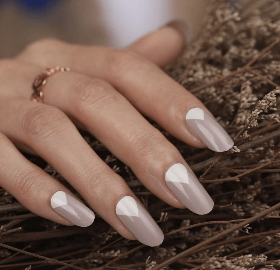 Hand wearing grey mountain geometric nail wraps with white triangle pattern design