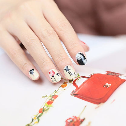 Holy Classics nail wraps, cream base with black bauble and red berry accents, one black snowflake tip