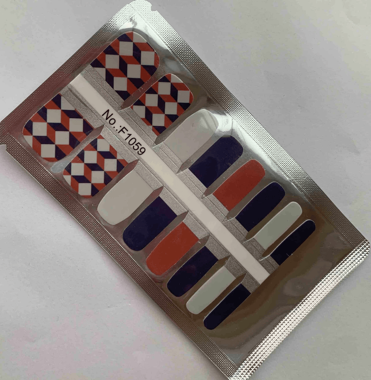Harlequin diamond pattern non-UV pedicure nail wraps in orange navy white geometric design
