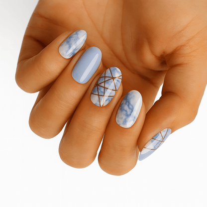 Blue marble geometric nail wraps with white stone effect on hand
