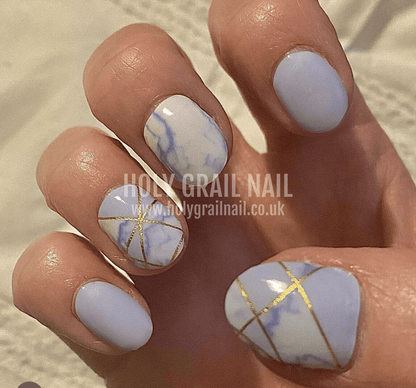 Pale blue nail wraps with marble effect and gold geometric line accents, wide fit