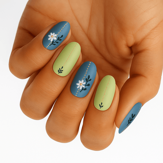 Blue and sage green nail wraps with white floral botanical designs on hand