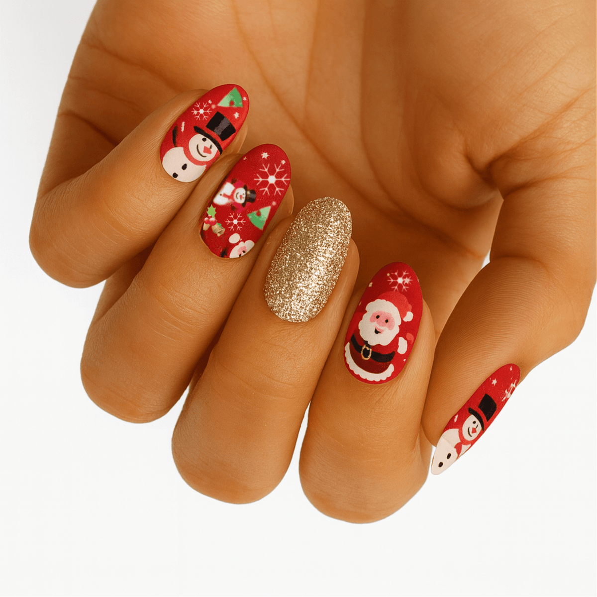 Hand wearing festive Christmas nail wraps with Santa, snowmen and gold glitter accent nail