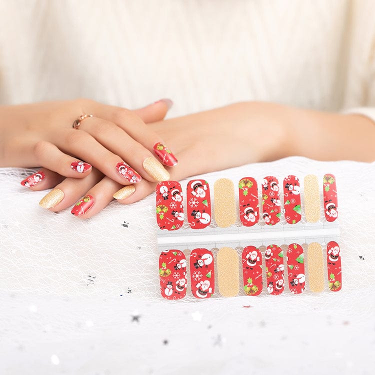 Red Christmas nail wraps with Santa and gold glitter designs on hands
