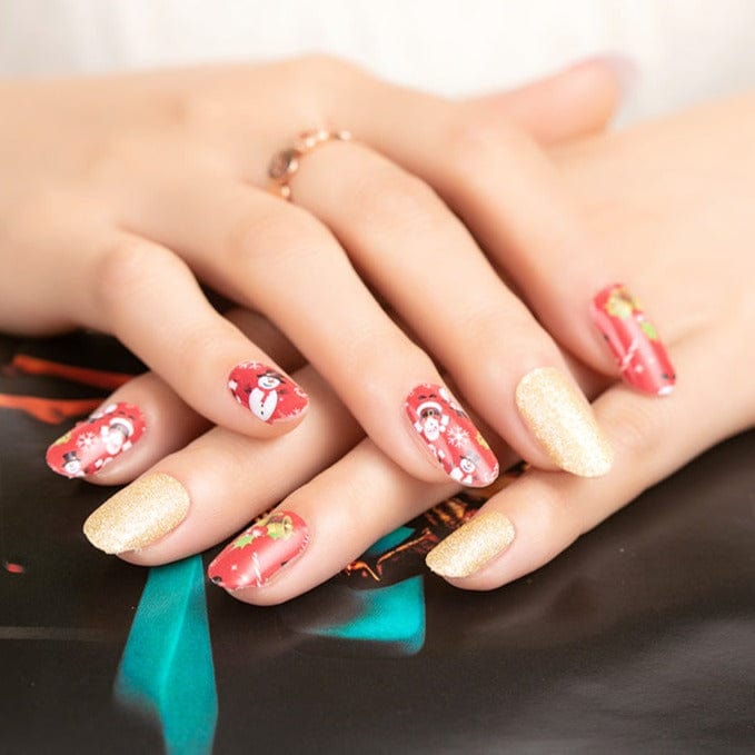 Christmas themed nail wraps featuring Santa designs and gold glitter on hands