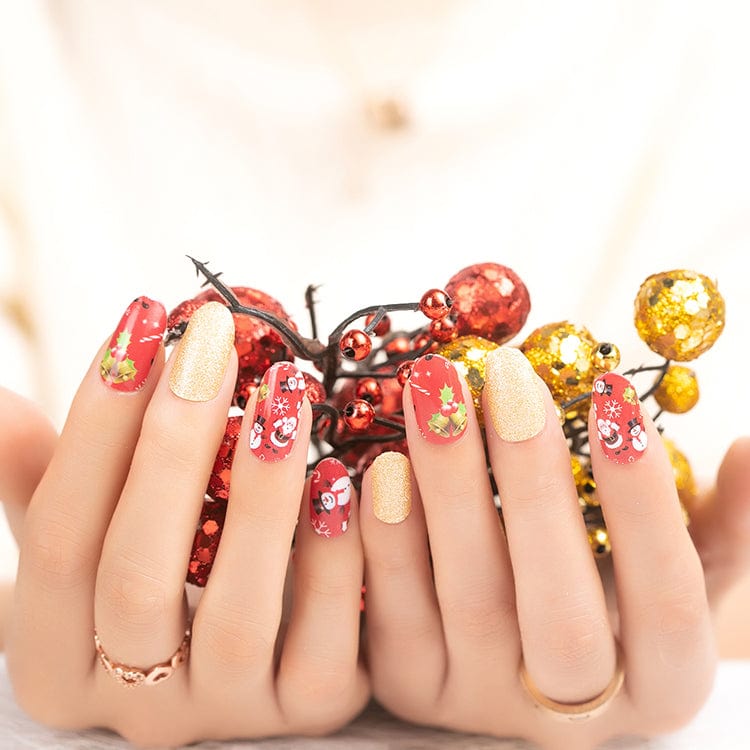 Festive Christmas nail art with Santa patterns and gold glitter nail wraps on hands