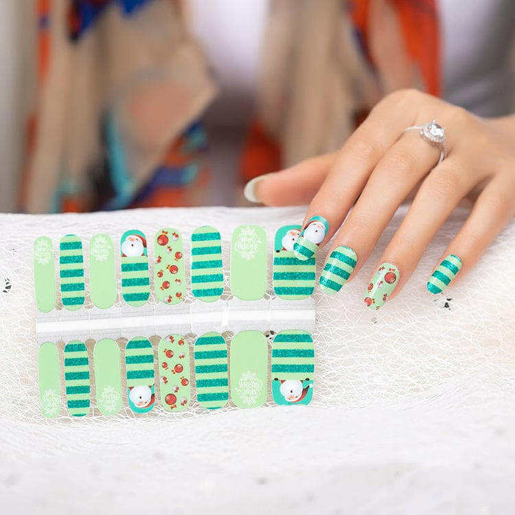 Christmas nail wrap sheet displaying Santa and green striped holiday nail art designs