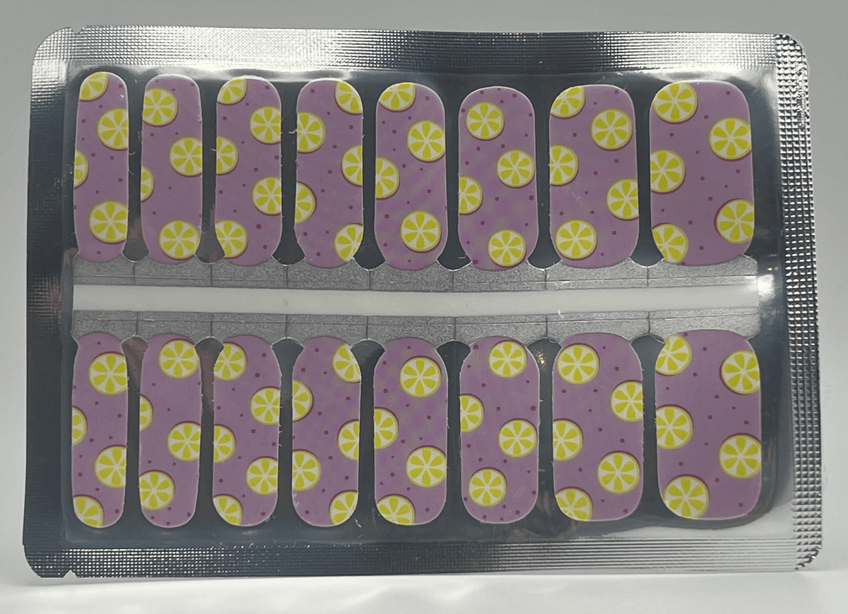 Pink nail wraps with yellow citrus lemon pattern in packaging for DIY nail art