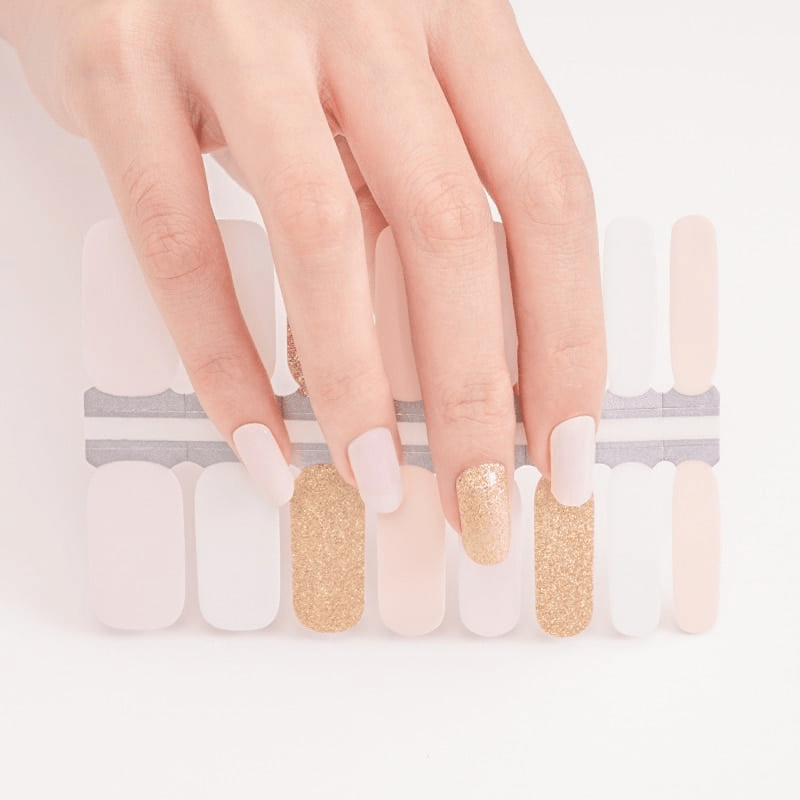 Sheer nude Holy Classics nail wraps with gold glitter accent nails on display sheet