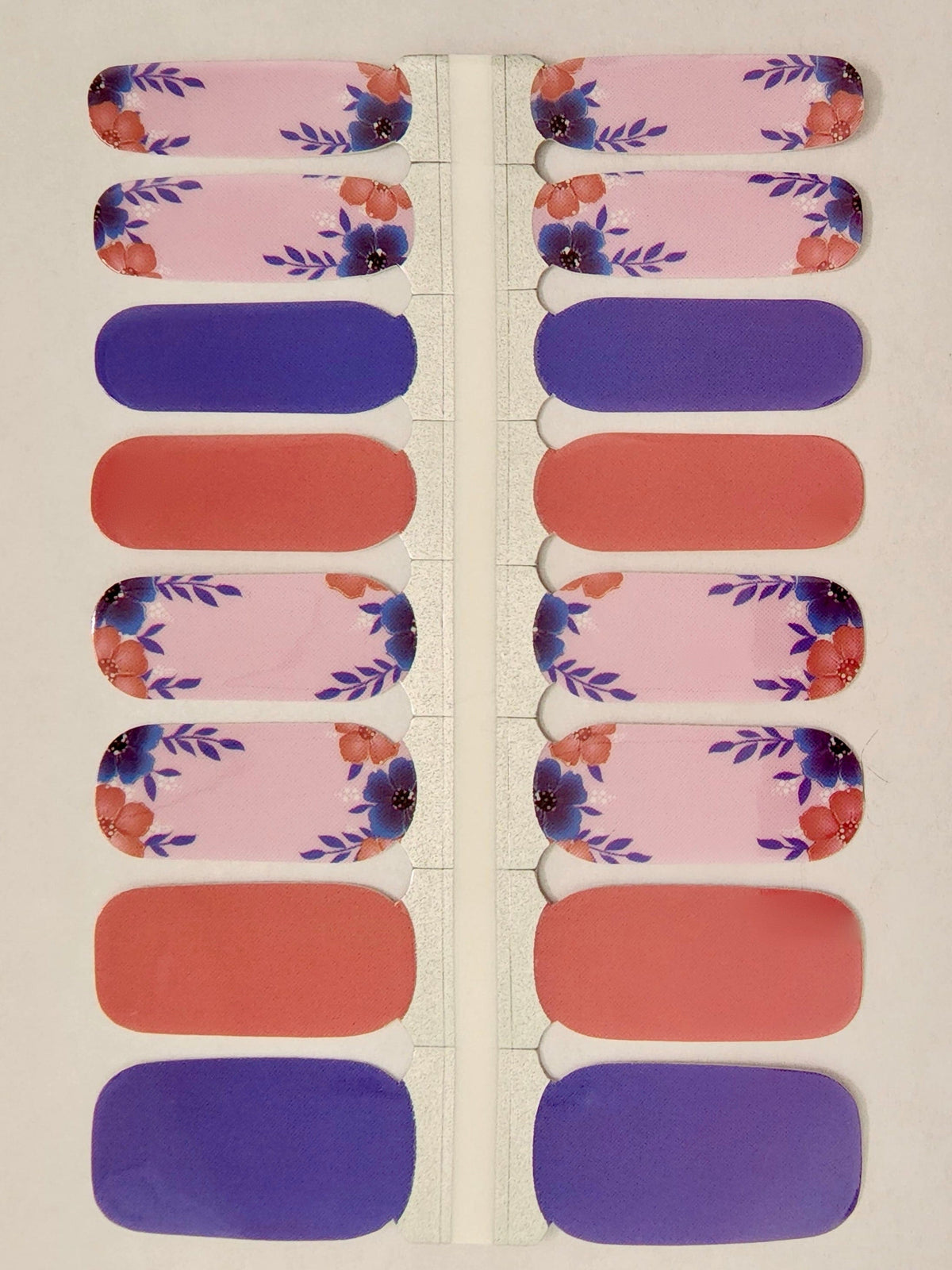 Pink floral nail wraps with purple and coral colour block designs on sheet