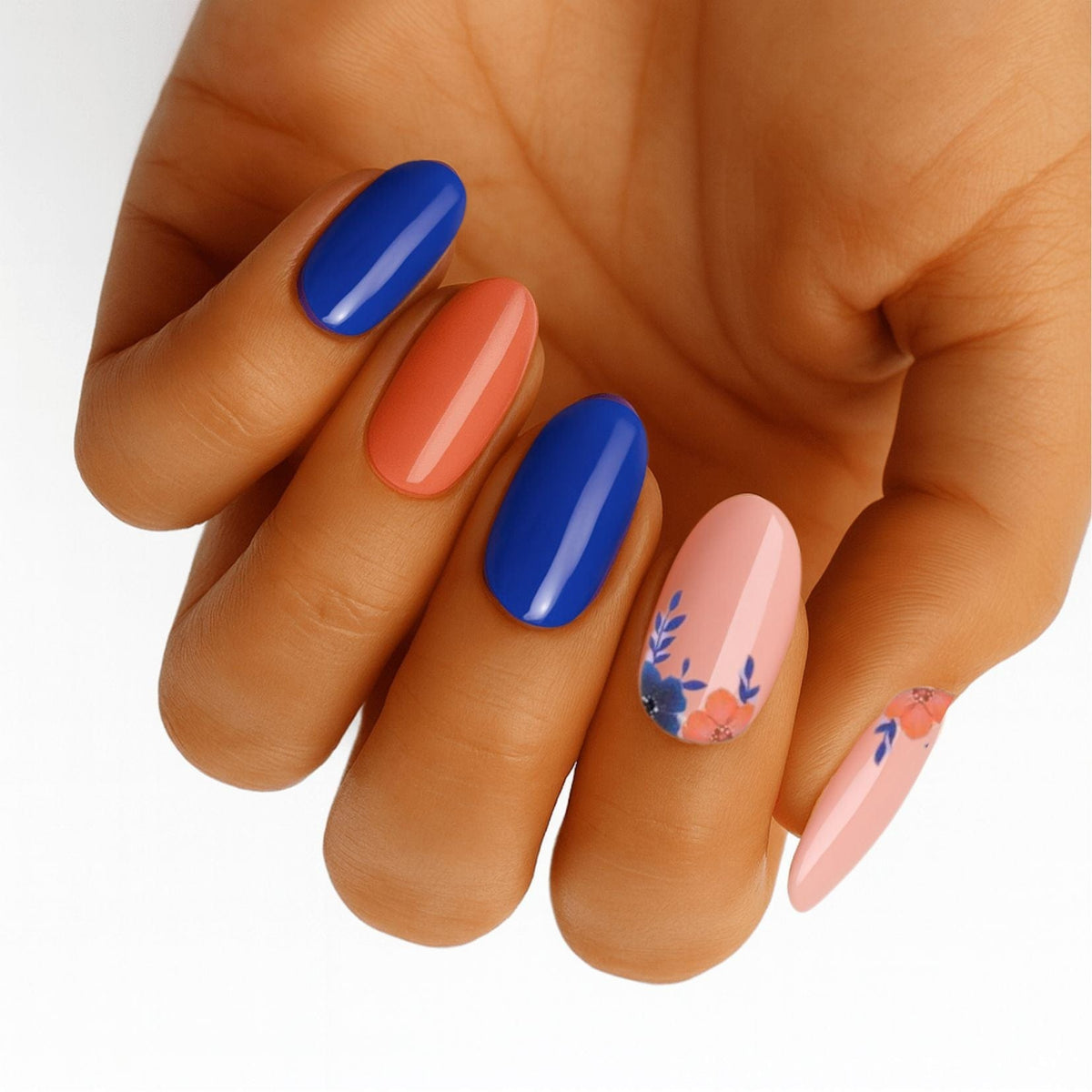 Bright coral blue nail wraps with floral accents in coastal colour block design on hand