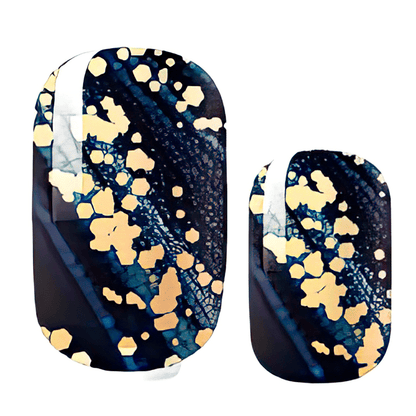Navy blue nail wraps with gold glitter speckles and celestial pattern for at-home manicure