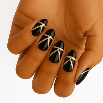 Black nail wraps with gold geometric art deco pattern on hand elegant manicure