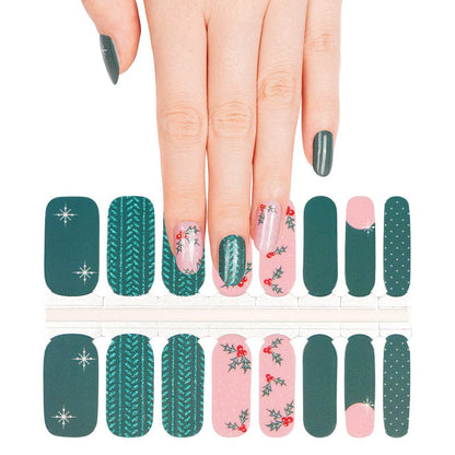Christmas nail wrap sheet featuring green knit patterns, pink holly designs and festive winter nail art