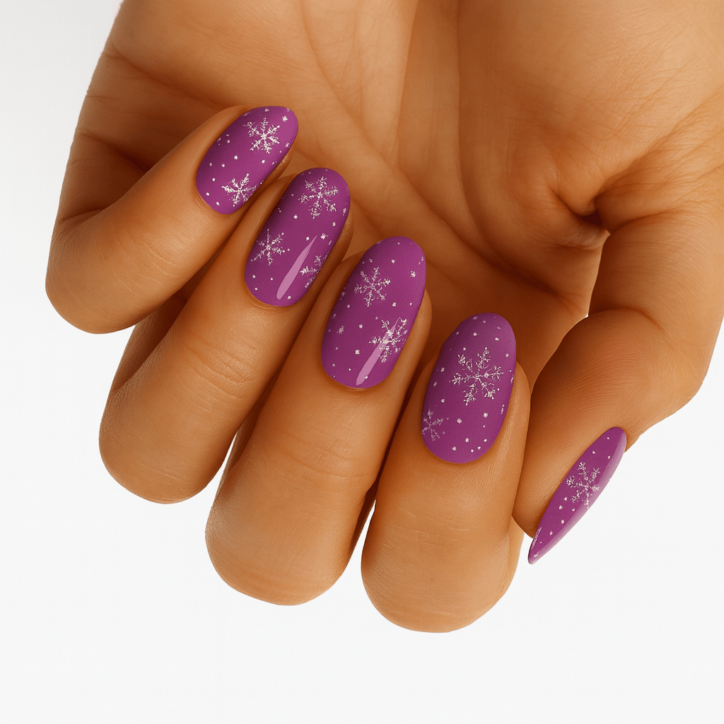 Purple glitter Christmas nail wraps with silver snowflakes applied on hand for festive manicure