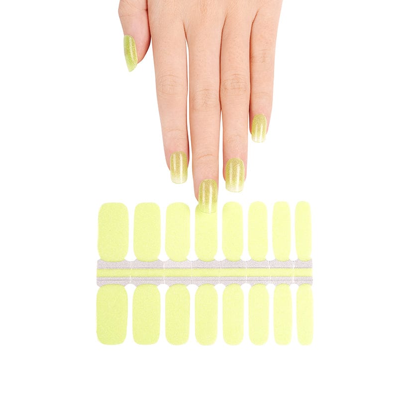 Hand displaying lime green shimmer nail wraps with non-UV wrap sheet below