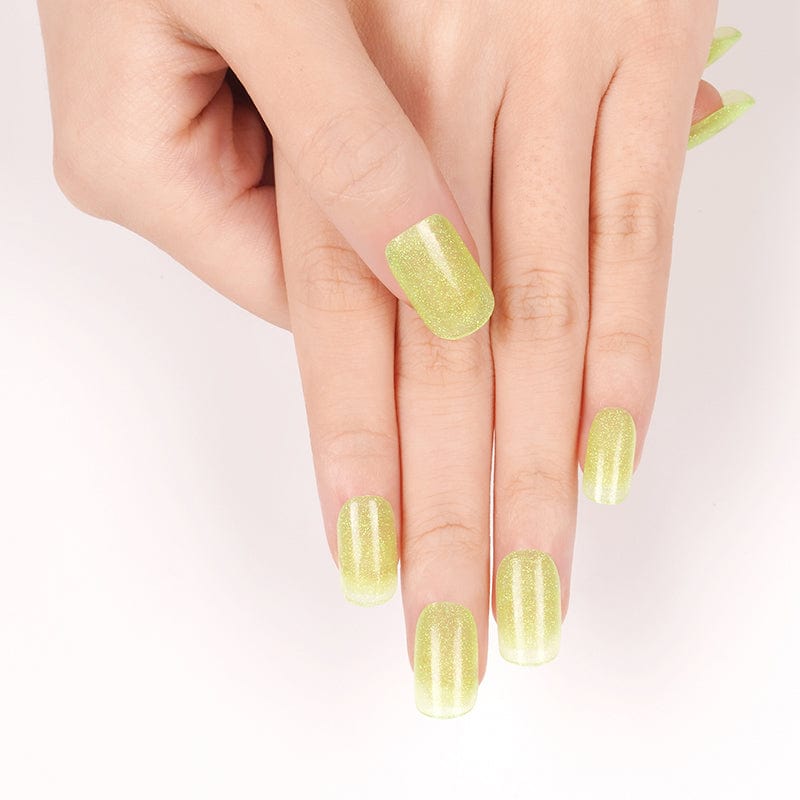 Bright lime green glitter nail wraps on hand showing shimmery metallic finish