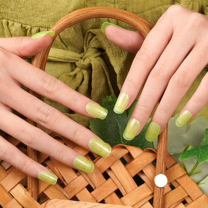 Sheer lime-green shimmer nail wraps in a glossy finish on short square nails