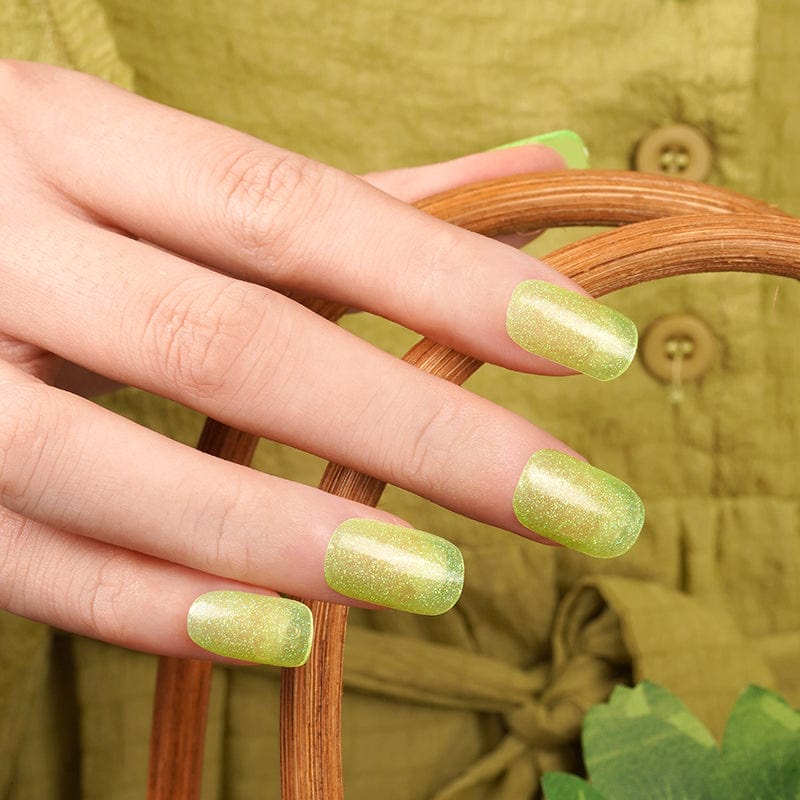 Key lime green glitter nail wraps on hand with sheer metallic finish