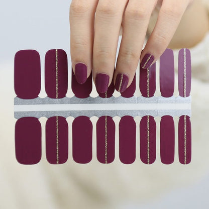 Burgundy nail wraps with a single gold glitter vertical stripe accent
