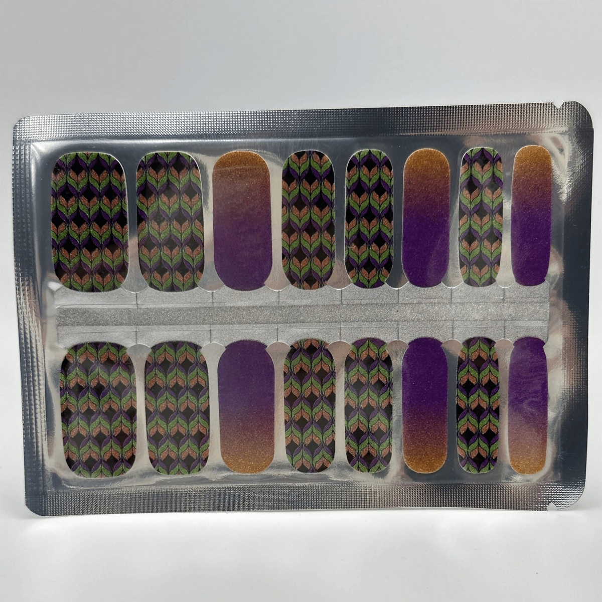 Holy Classics nail wraps with green-purple leaf pattern and purple-to-gold ombre accent nails