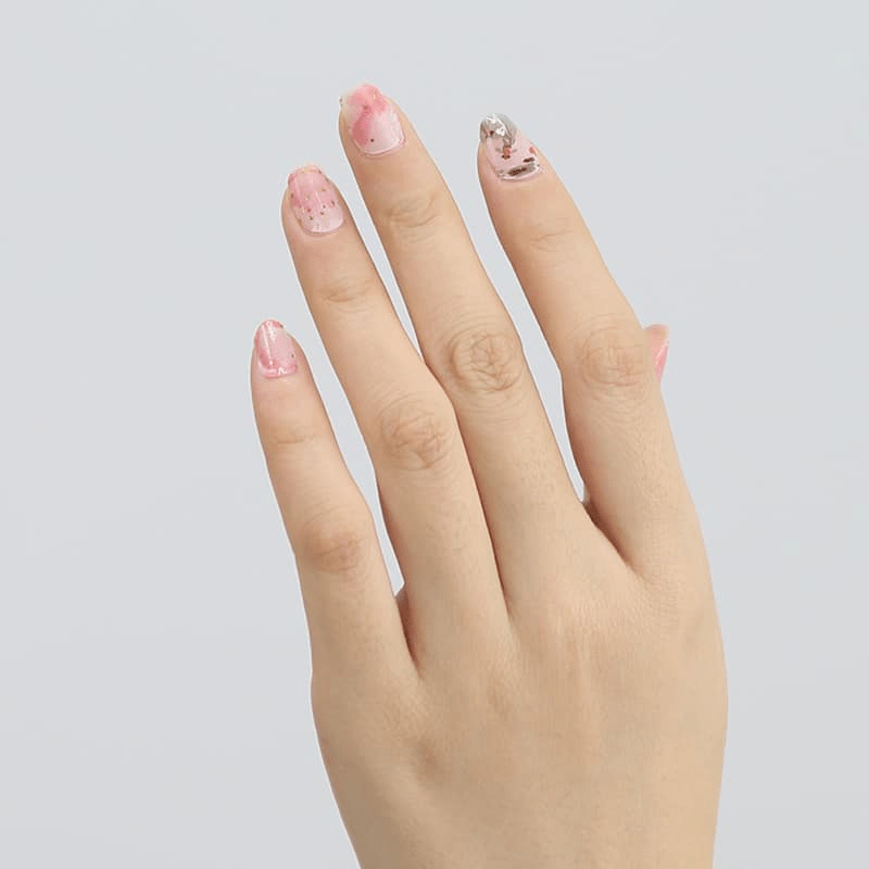 Manicured hand showing pink and grey koi fish nail art wraps design