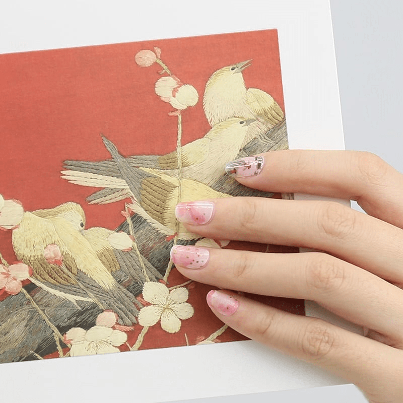 Asian inspired koi fish nail wraps in soft pink watercolour on hand