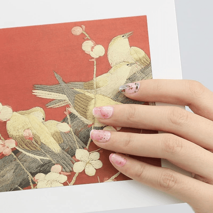 Asian inspired koi fish nail wraps in soft pink watercolour on hand