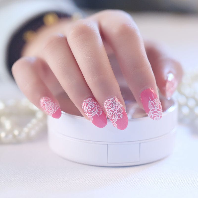 Elegant pink nail wraps with delicate white rose lace design for at-home manicure