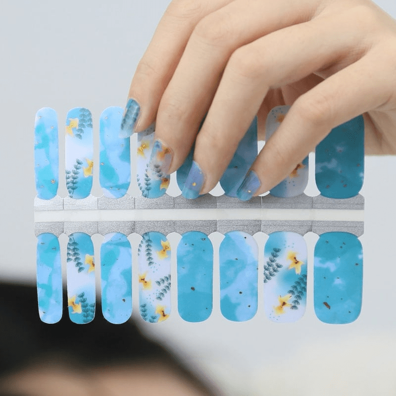 Blue floral nail wraps with botanical watercolour pattern on application sheet