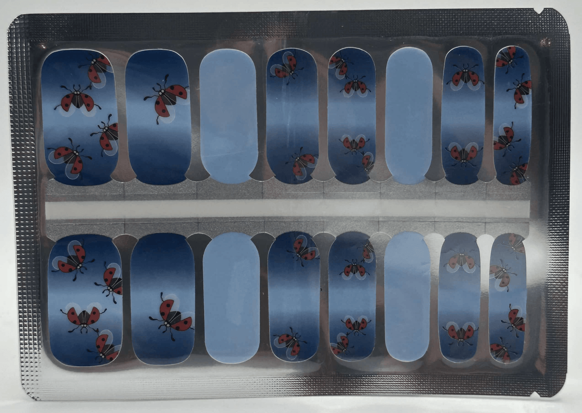 Non-UV nail wraps sheet featuring blue gradient with red ladybird cartoon design for at-home manicure