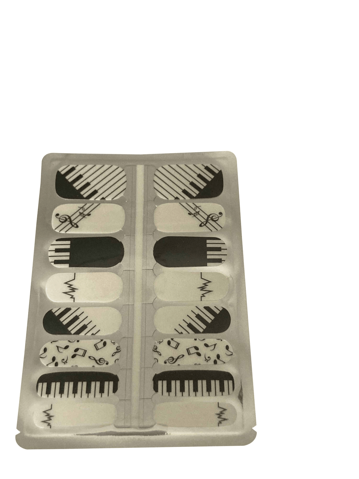 Black and white music themed nail wraps with piano keys and musical notes pattern