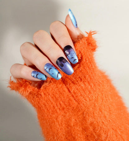Blue-to-purple ombré nail wraps with shimmer finish, bat silhouettes and moon design