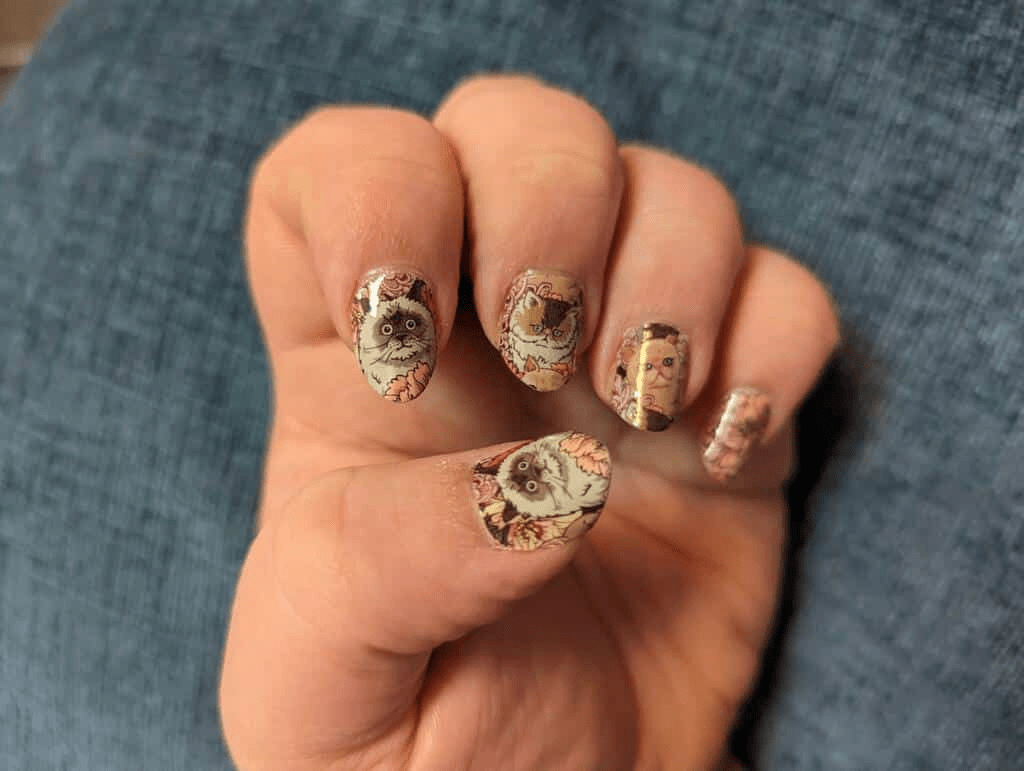 Vintage cat floral nail wraps on hand with whimsical cottagecore design