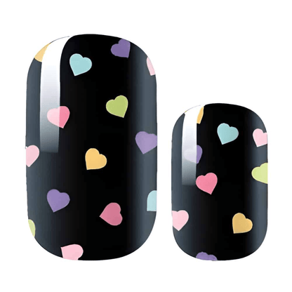 Black nail wraps with colourful heart pattern featuring pastel pink, purple, yellow and blue hearts