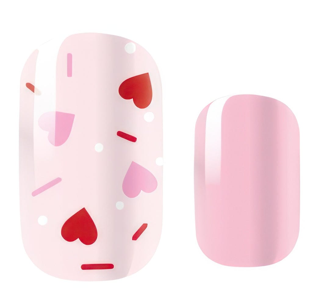 Pink nail wraps with red hearts and sprinkles pattern for Valentine's manicure