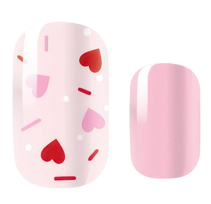 Pink nail wraps with red hearts and sprinkles pattern for Valentine's manicure