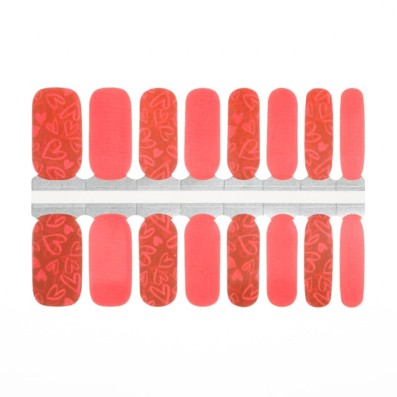 Coral and red heart pattern nail wraps with romantic rose designs for Valentine's Day manicure